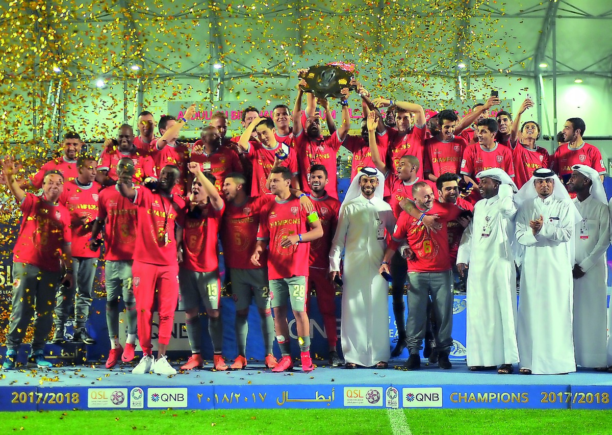Al Duhail players and officials celebrate with the 2017 QNB Stars League trophy in this file photo.