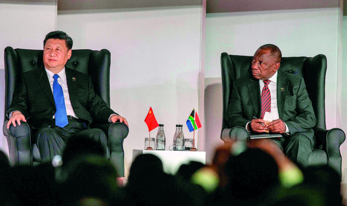 South Africa's President Cyril Ramaphosa (R) looks at China's President Xi Jinping as they attend a Business Forum organised during the 10th BRICS (acronym for the grouping of the world's leading emerging economies, namely Brazil, Russia, India, China and