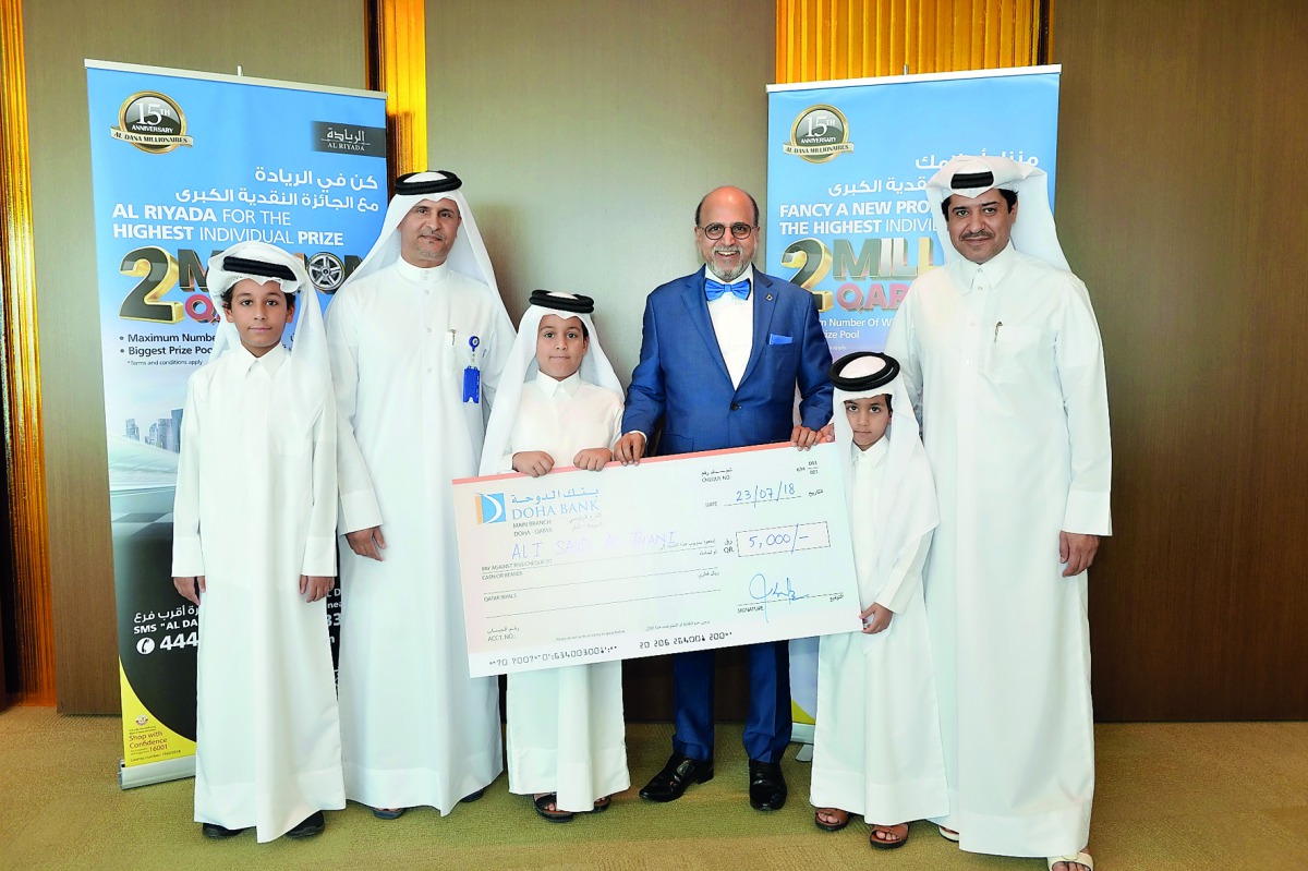 Dr R Seetharaman (second right) CEO of Doha Bank and others with ‘Al Dana Young Saver’ winner.