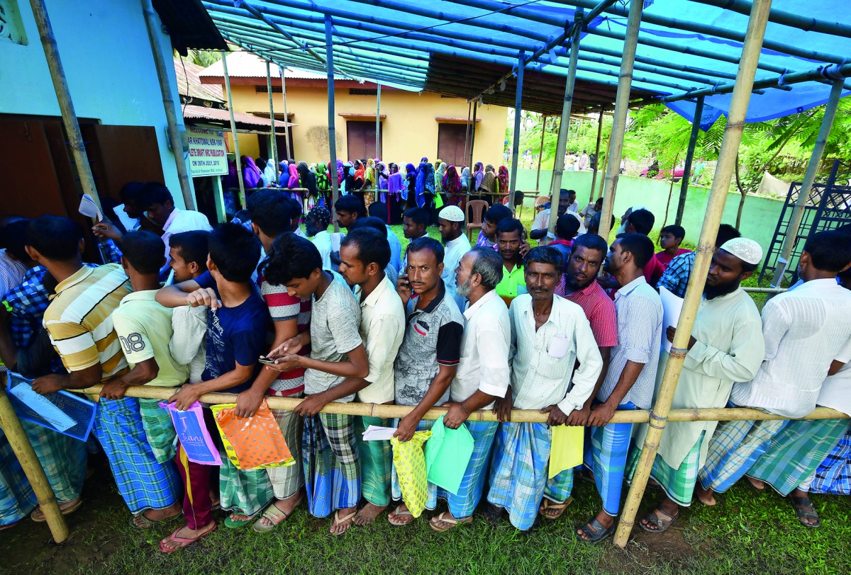 People wait in queue to check their names on the draft list at the National Register of Citizens (NRC) centre at a village in Nagaon district, Assam state, India, July 30, 2018. Reuters