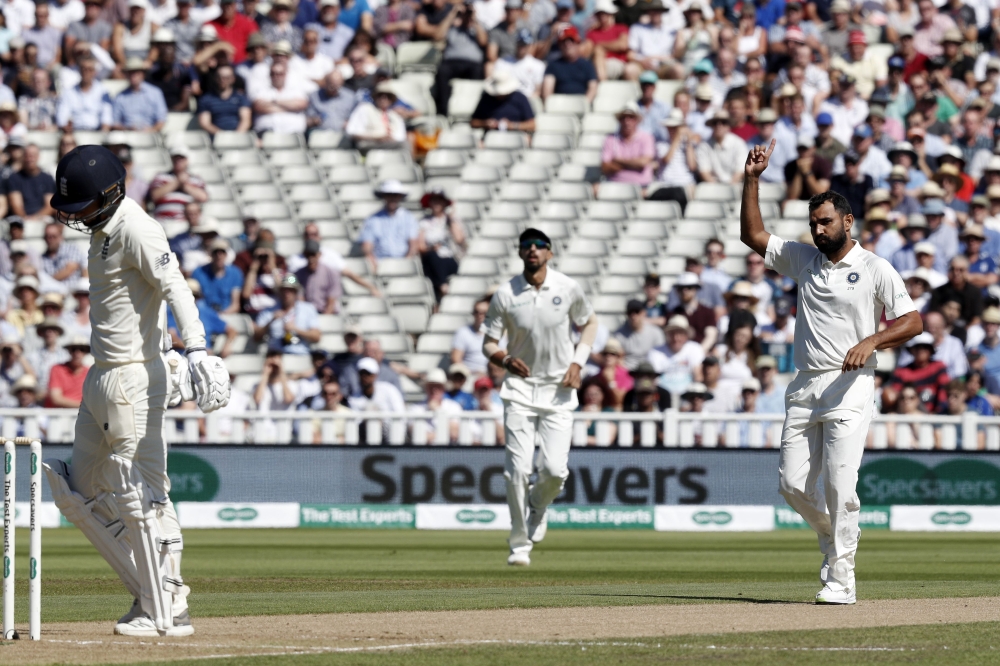 India's Mohammed Shami (R) gestures after taking the wicket of England's Sam Curran (L) to end their innings on the second day of the first Test cricket match between England and India at Edgbaston in Birmingham, central England on August 2, 2018. (AFP / 