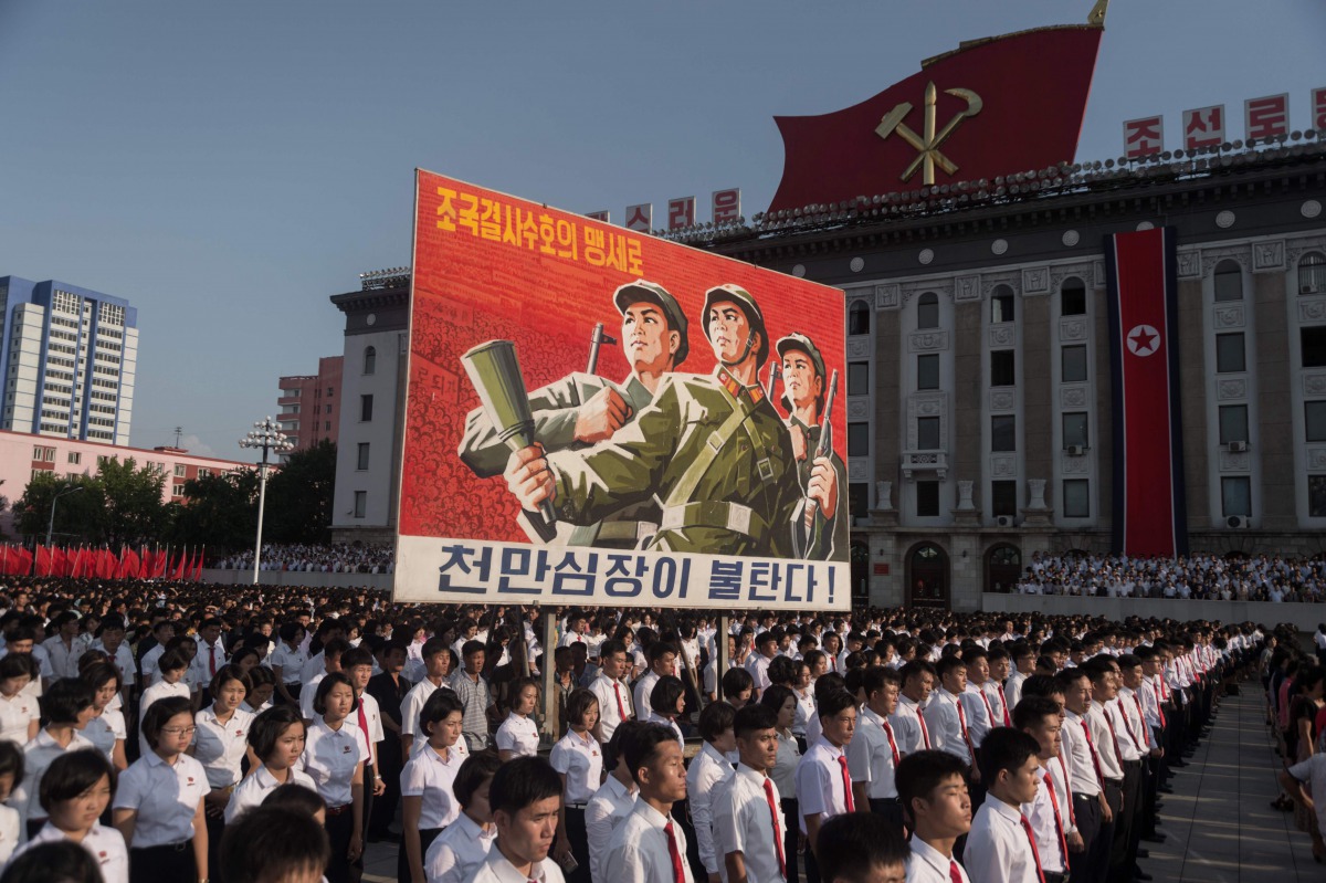 People attend a rally in support of North Korean stance against the US on Kim Il-Sung square in Pyongyang on August 9, 2017.  Nearly half of North Korea's population - 10 million people - are undernourished, according to UN officials, who have reported a 