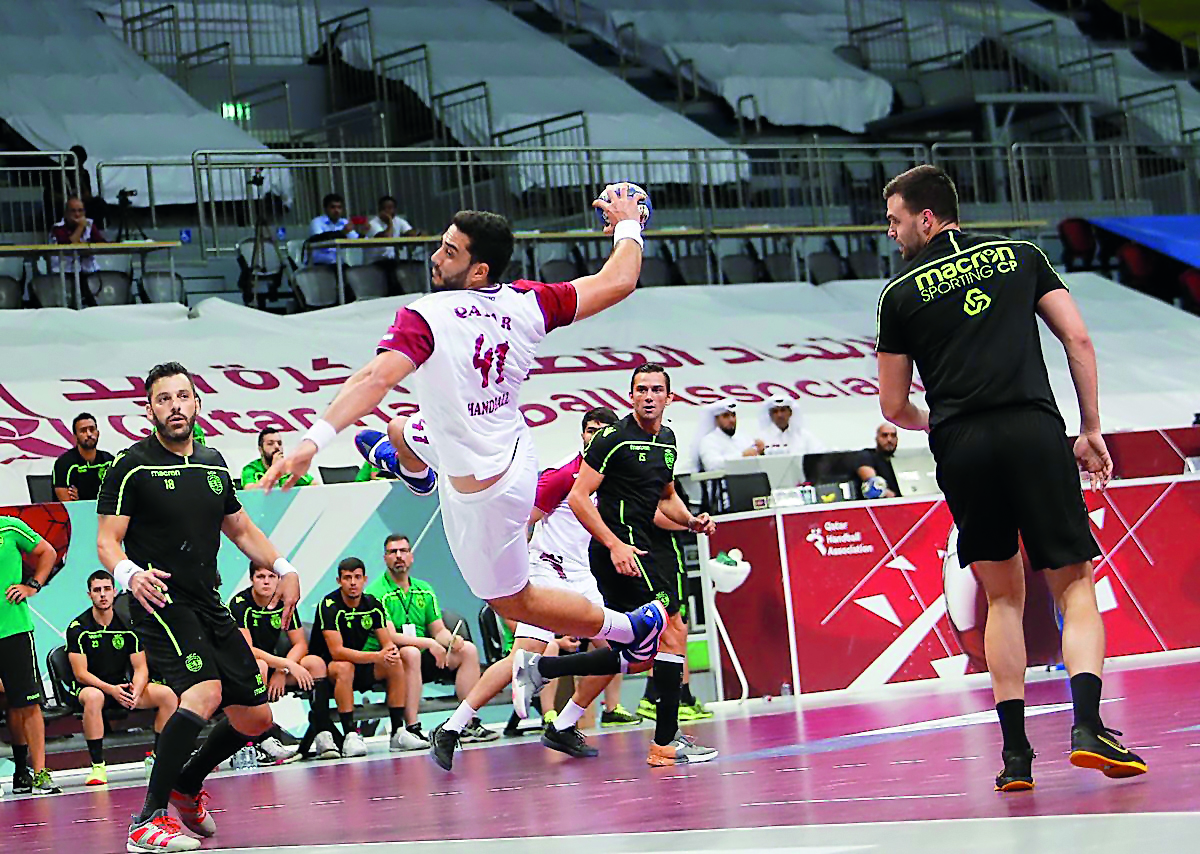 A Qatari player scores during the friendly match against Lisbon at Duhail Sports Hall yesterday.