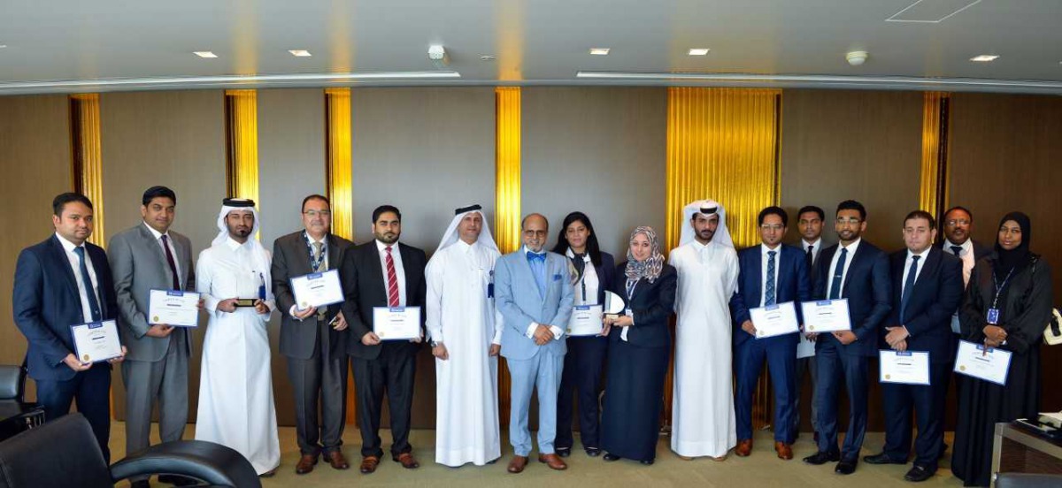 Dr R Seetharaman (seventh left), Group CEO of Doha Bank, and other senior officials and employees of the Bank at the award ceremony.