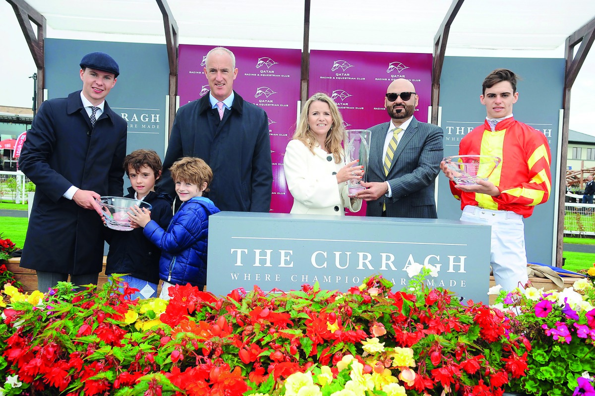 The winning team poses with the trophy.