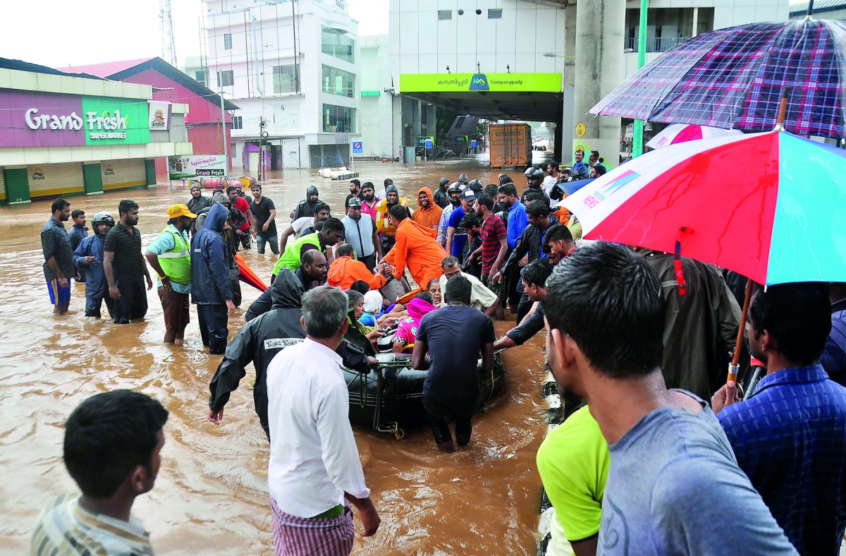 Indian navy and rescue personnel evacuate local residents in an boat at Aluva, in the Indian state of Kerala, on August 16, 2018. AFP
