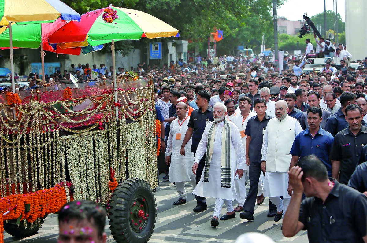 Prime Minister Narendra Modi and India's ruling Bharatiya Janata Party (BJP) President Amit Shah follow the hearse carrying the body of former prime minister Atal Bihari Vajpayee as they move towards the cremation site in New Delhi, India, August 17, 2018