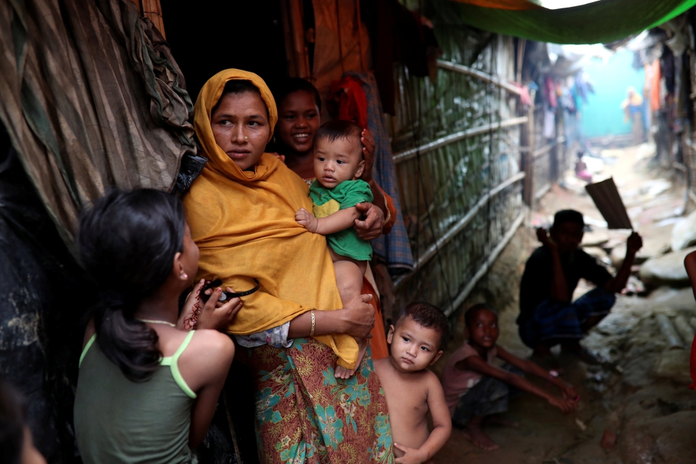 Rohingya refugees are seen outside of their makeshift tent in the Kutupalong camp in Cox's Bazar, Bangladesh August 24, 2018. Reuters/Mohammad Ponir Hossain