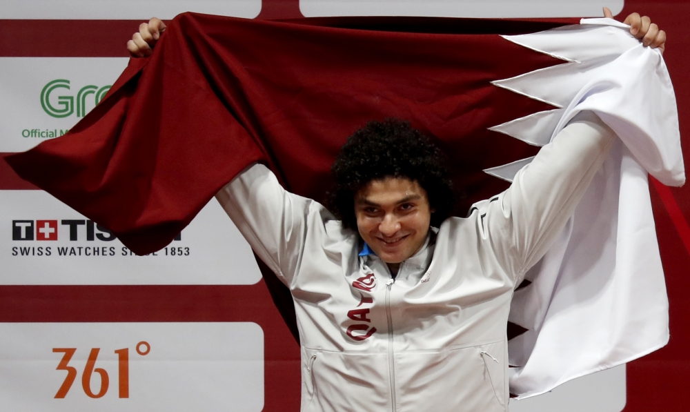 Silver medalist Fares Elbakh of Qatar celebrates on the podium. REUTERS/Beawiharta
