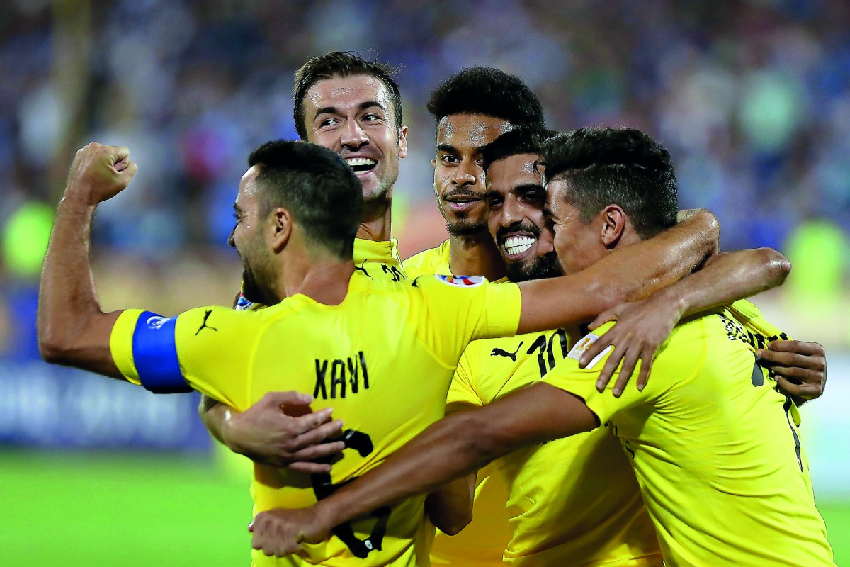Al Sadd players celebrate after scoring a goal against Esteghlal  during their AFC Champions League quarter-final (first leg) at the Azadi Stadium in Tehran, yesterday. 
