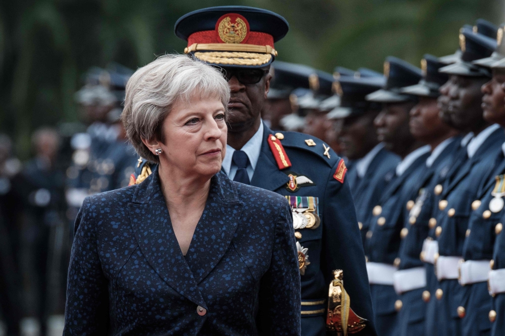 British Prime Minister Theresa May reviews a military guard of honour at the State House in Nairobi on August 30, 2018.   AFP / Yasuyoshi CHIBA

