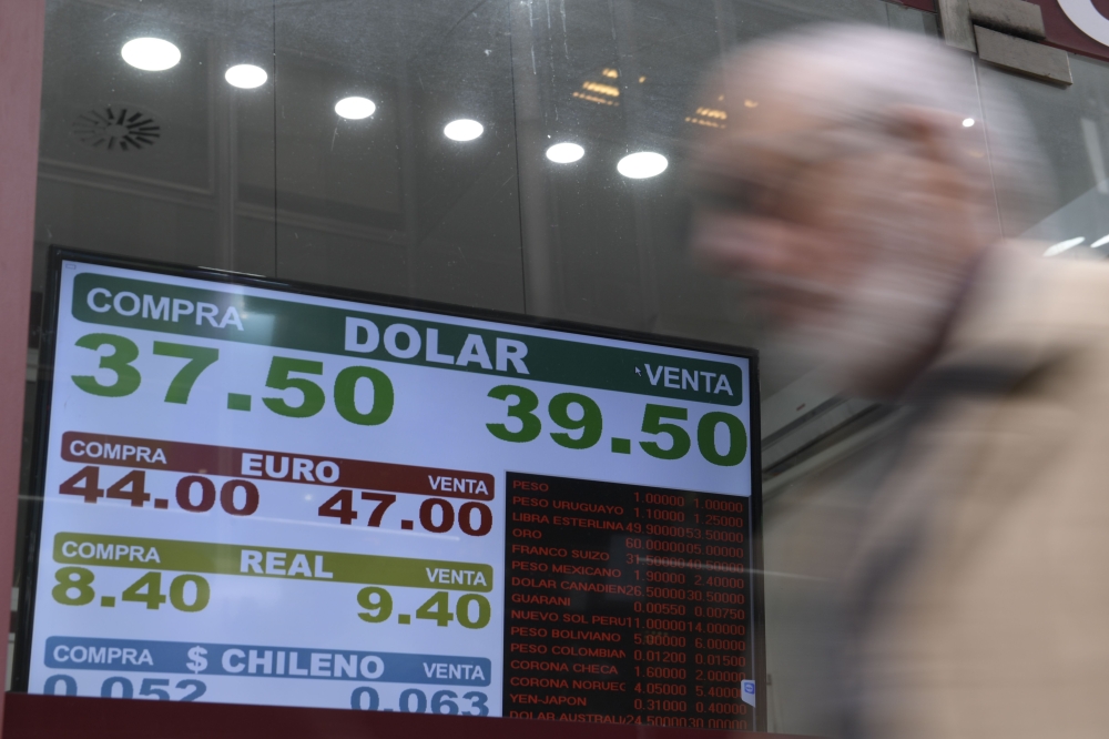 Currency exchange values are displayed in the buy-sell board of a bureau de exchange in Buenos Aires, on September 3, 2018.  AFP / Juan Mabromata
