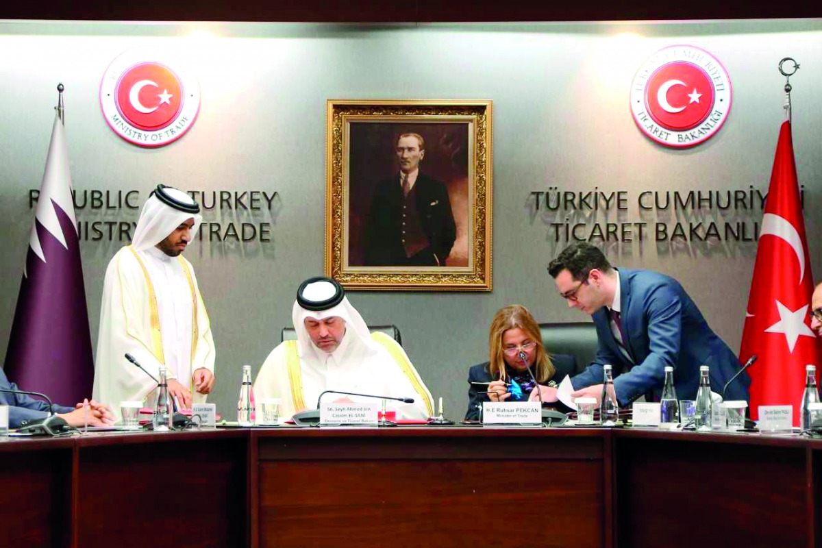 H E Sheikh Ahmed bin Jassim Al Thani (sitting left), Minister of Economy and Commerce, and his Turkish counterpart Ruhsar Pekcan, Minister of Trade of the Republic of Turkey, signing the documents of the agreement in Ankara, yesterday. 