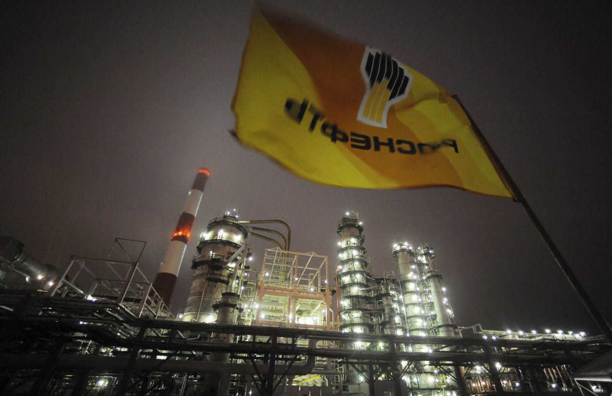 A flag with the logo of Rosneft, Russias largest oil company, flutters over the Novokuibyshevsk refinery near the city of Samara, October 28, 2010. Reuters/Nikolay Korchekov