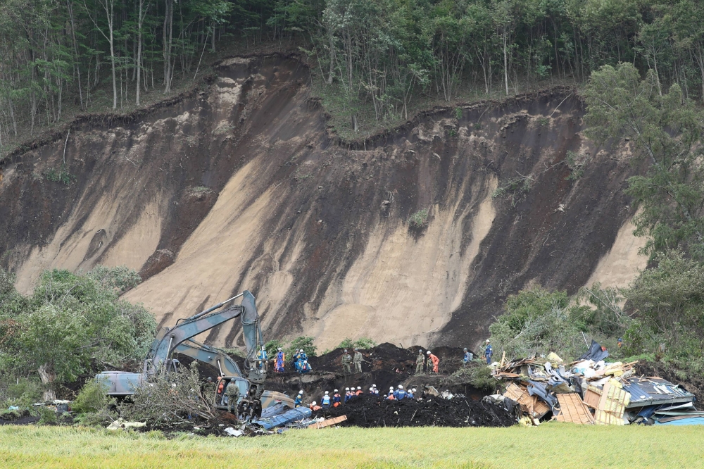 Rescue workers search for missing people in Astuma on September 8, 2018 after a 6.6-magnitude earthquake hit the northern Japanese island of Hokkaido on September 6. Japan OUT / AFP / JIJI PRESS / Jiji Press 
