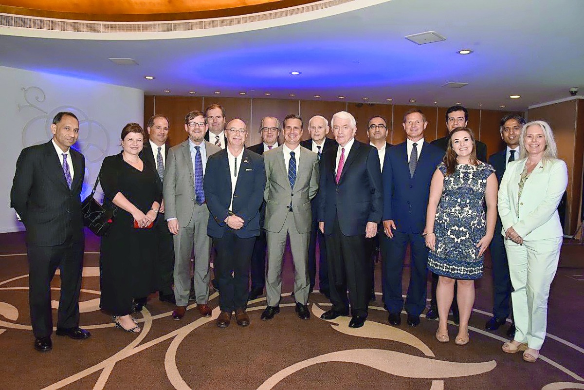 The visiting delegation and some of the attendees pose for a picture.