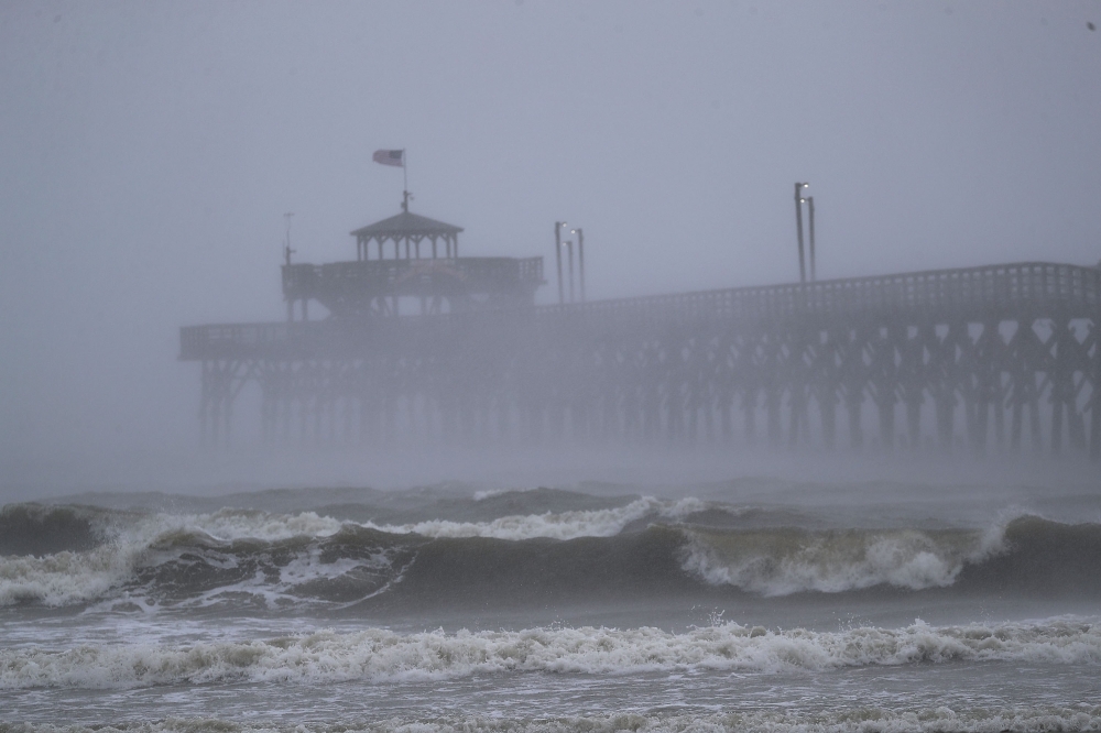 Waves created by Hurricane Florence are seen along Cherry Grove Fishing Pier on September 14, 2018 in North Myrtle Beach, United States. Joe Raedle/Getty Images/AFP  