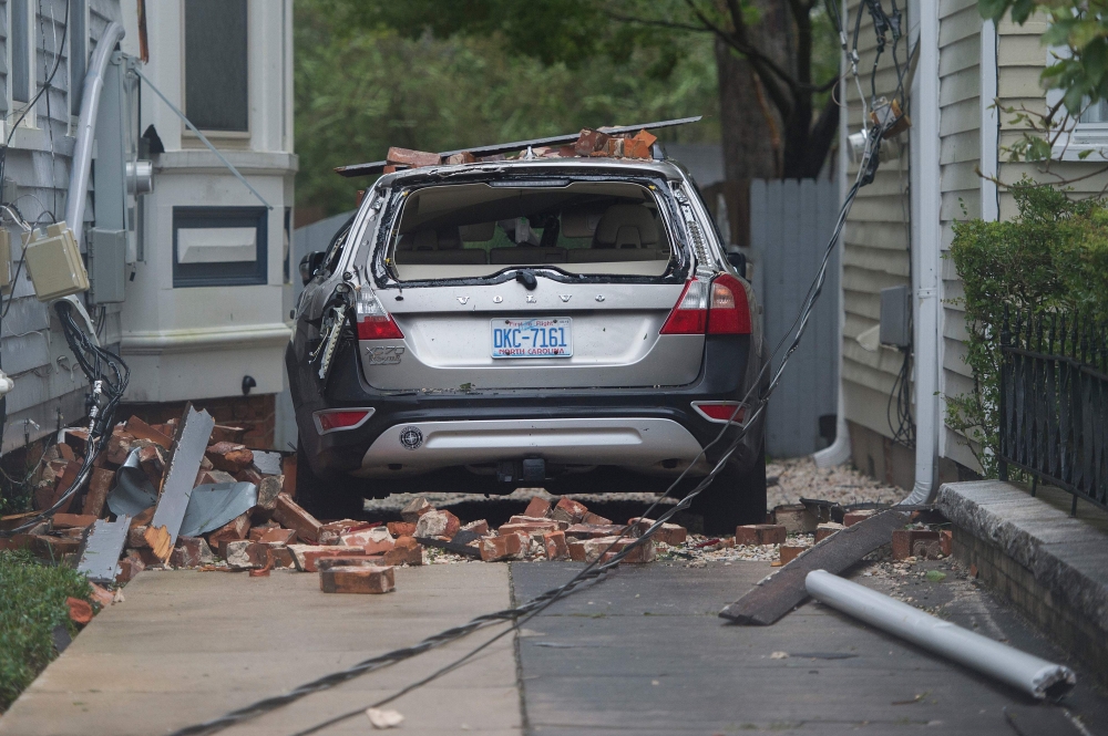 A car is destroyed from falling bricks as Hurricane Florence passes over Wilmington, North Carolina on September 14, 2018. AFP / Andrew Caballero-Reynolds
 