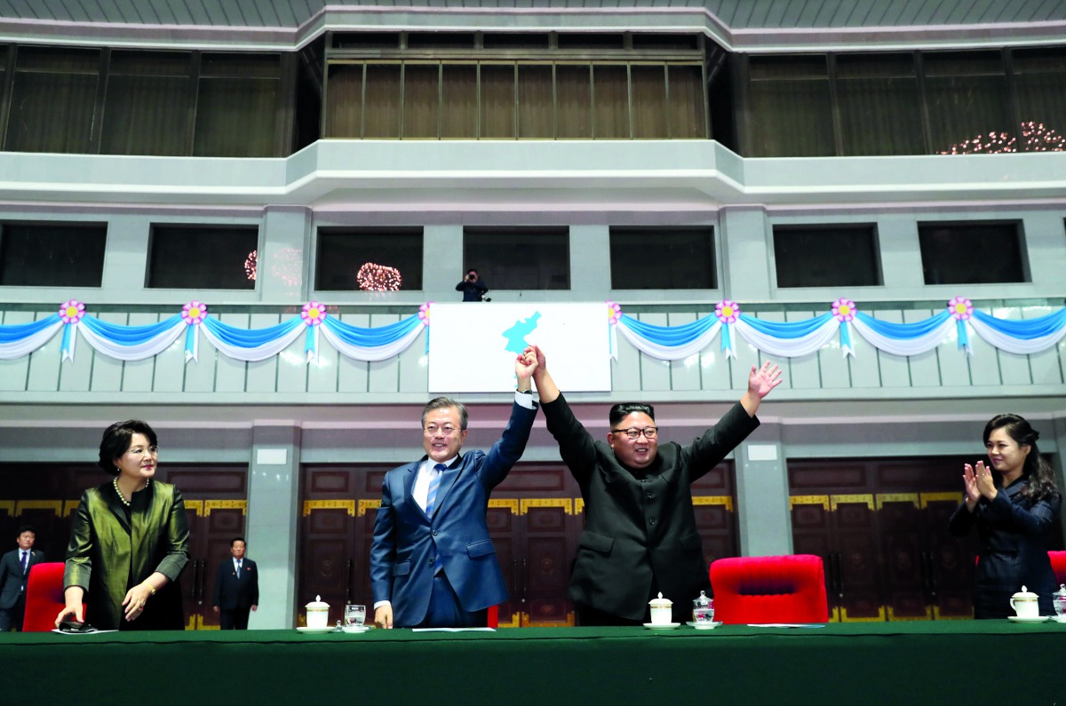 South Korean President Moon Jae-in and North Korean leader Kim Jong Un acknowledges the audience after watching the performance titled 