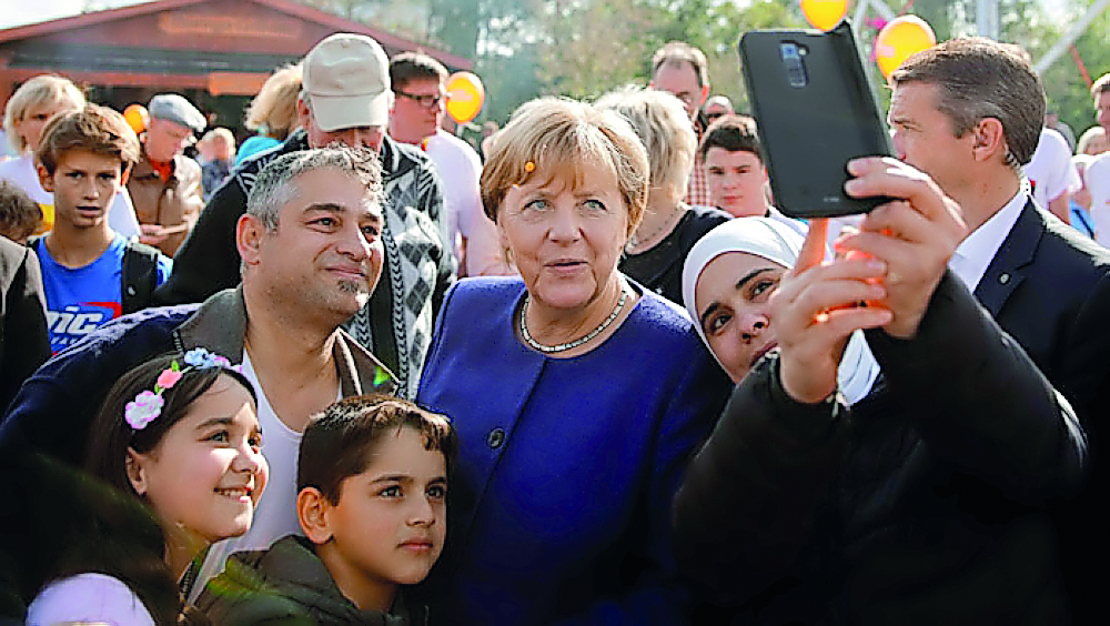 German Chancellor Angela Merkel, a top candidate of the Christian Democratic Union Party (CDU) for the upcoming general elections poses for a selfie during an election rally in Stralsund, Germany September 16, 2017. Reuters/Axel Schmidt