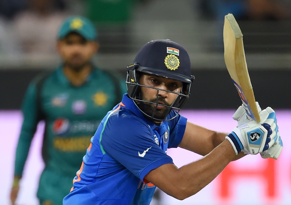 Indian cricket team captain Rohit Sharma plays a shot during the one day international (ODI) Asia Cup cricket match between Pakistan and India at The Dubai International Cricket Stadium in Dubai on September 19, 2018. / AFP / ISHARA S. KODIKARA
