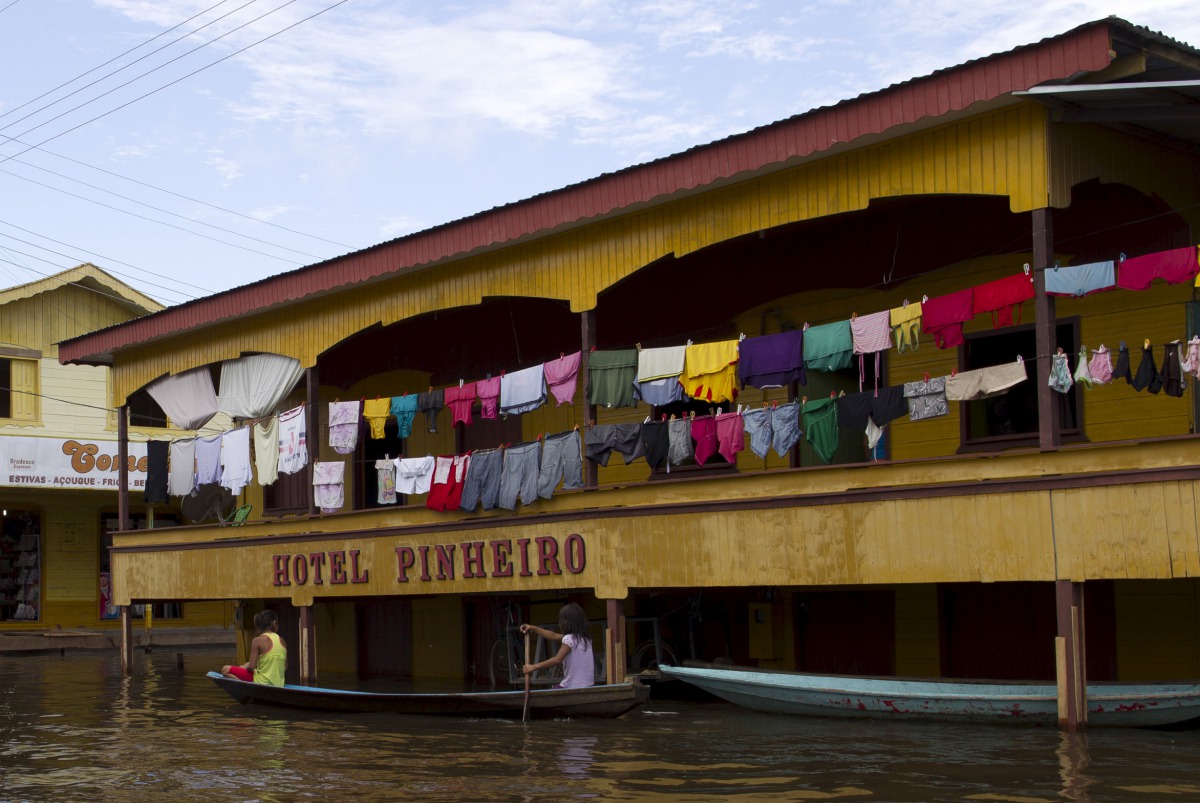 Residents paddle their canoe in a street flooded by the rising Rio Solimoes, one of the two main branches of Amazon River, in Anama, Amazonas state, Brazil on May 28, 2015. Bruno Kelly/Reuters