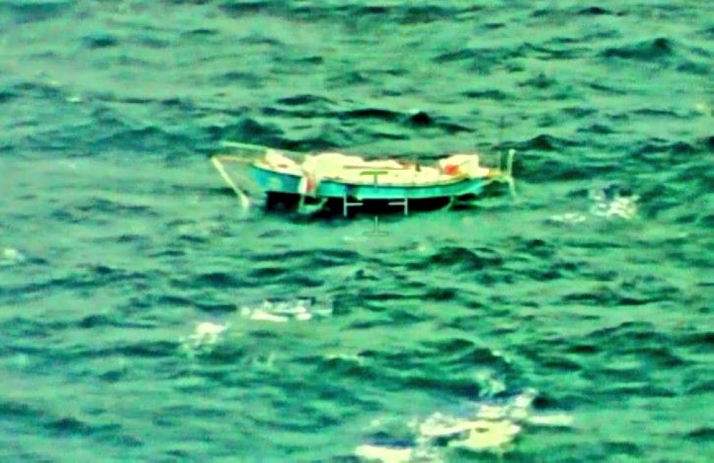 The capsized yacht Thuriya of solo sailor Abhilash Tomy is pictured at sea in this September 24, 2018 handout photo by the Indian Navy. Indian Navy 

