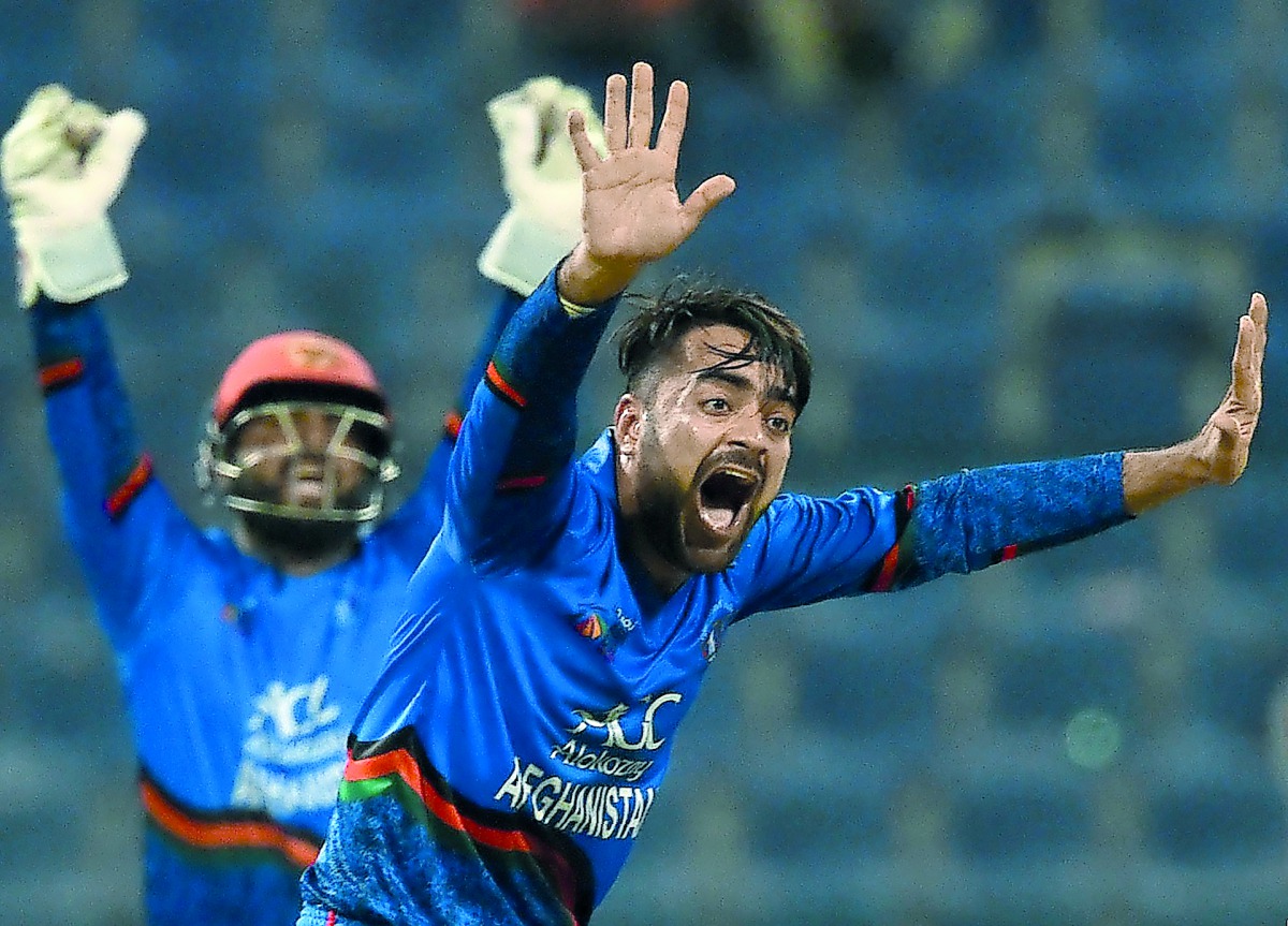Afghan cricketer Rashid Khan (R) appeals for an unsuccessful leg before wicket (LBW) decision against unseen Bangladesh batsman Mosaddek Hossain during the one day international (ODI) Asia Cup cricket match between Bangladesh and Afghanistan at The Sheikh