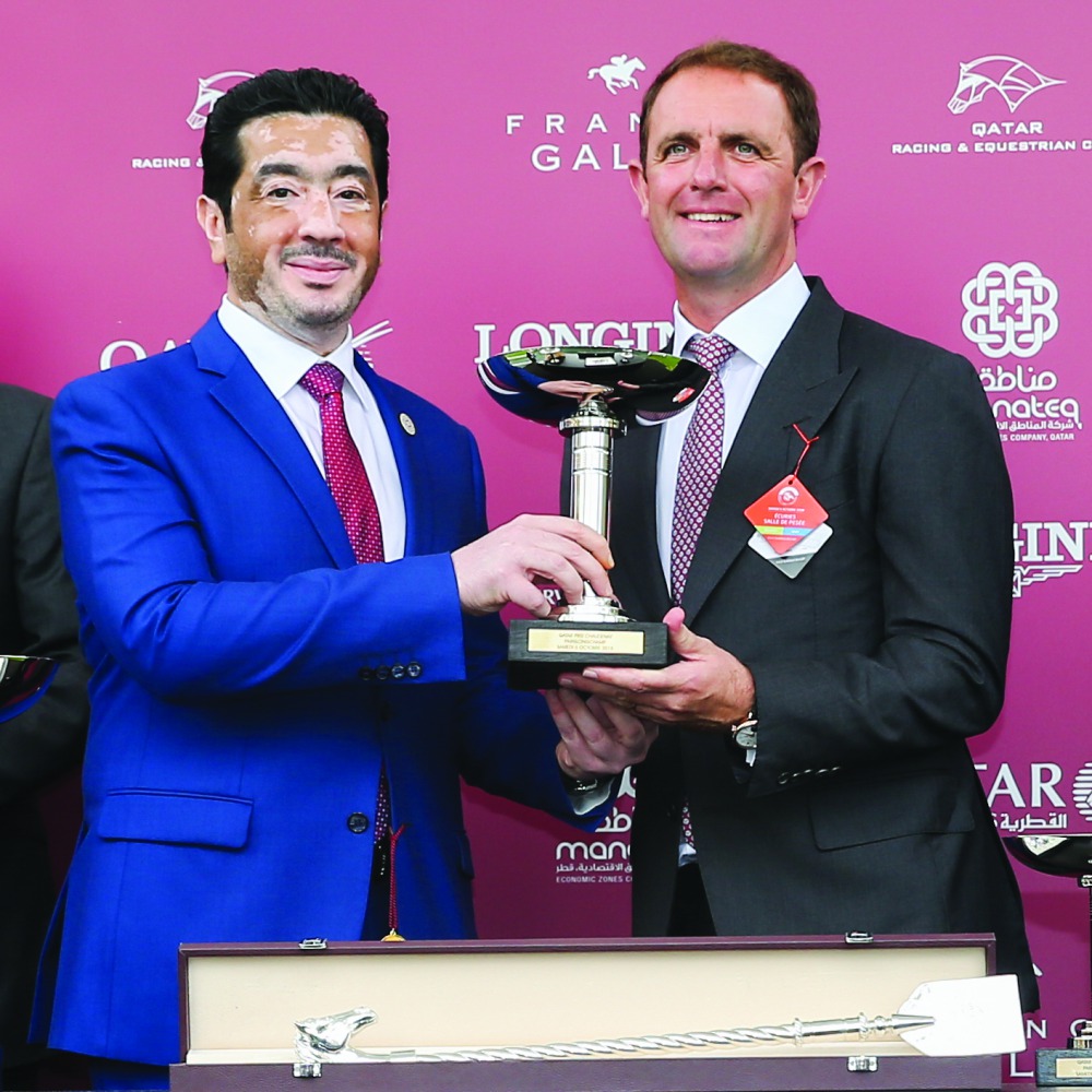 Fahad Rashid Al Kaabi, CEO of Manateq, presents a trophy in Paris yesterday. 