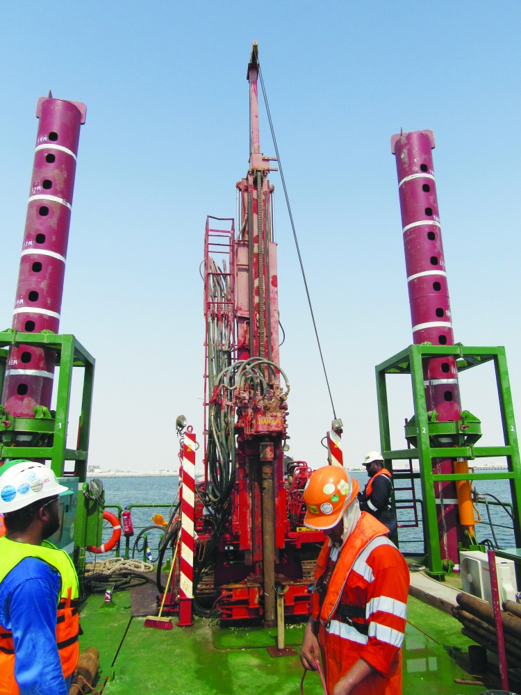 Engineers and technicians working on the Gulf Laboratories Co’s new jack-up drilling platform—Ammonite.