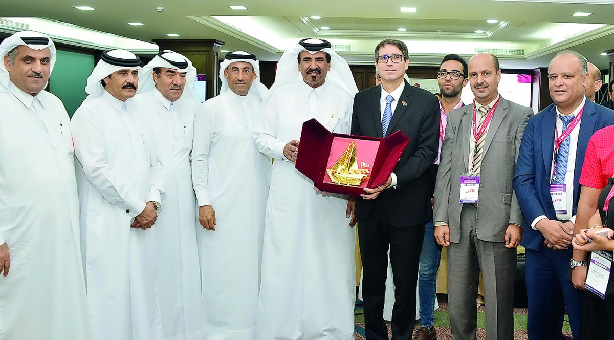 Nabil Zniber (fourth right), the Moroccan Ambassador to Qatar, receiving a memento from Mohamed bin Ahmed bin Towar Al Kuwari (centre), Vice-Chairman, Qatar Chamber, as other QC officials and visiting ASMEX delegation look on, yesterday at QC premises.