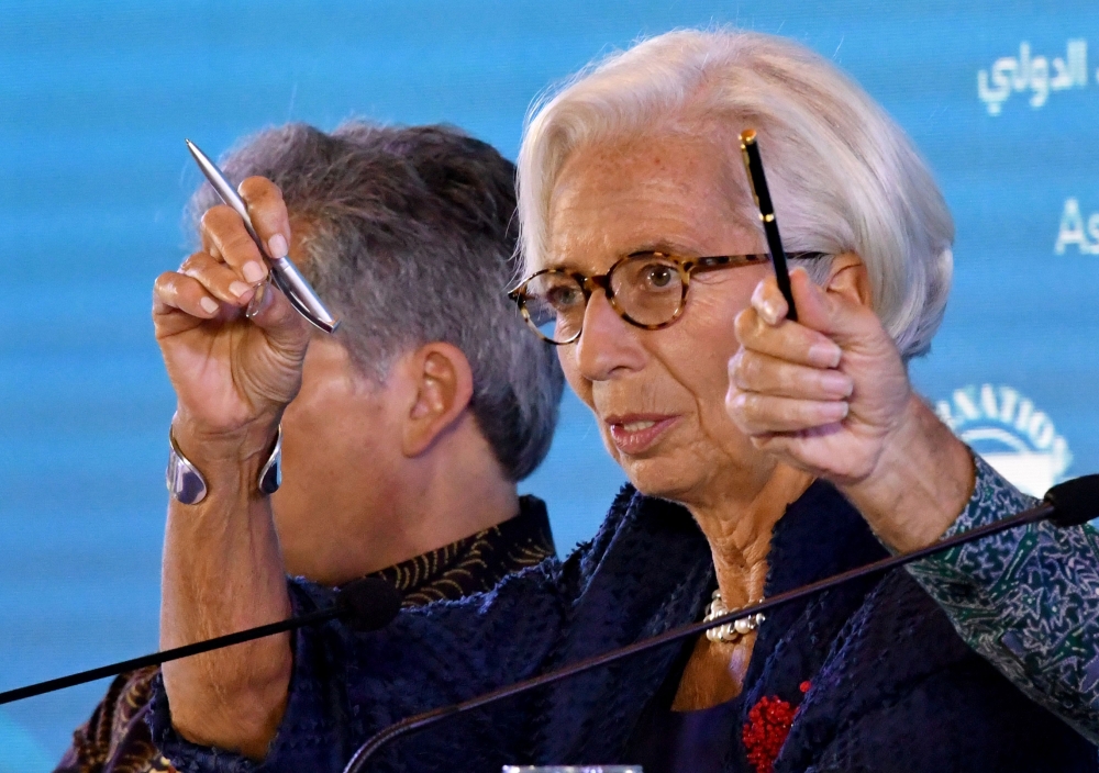 International Monetary Fund chief Christine Lagarde (R) gestures during her press conference at the International Monetary Fund (IMF) and World Bank annual meetings in Nusa Dua on Indonesia’s resort island of Bali on October 11, 2018.  / AFP / Goh Chai Hi