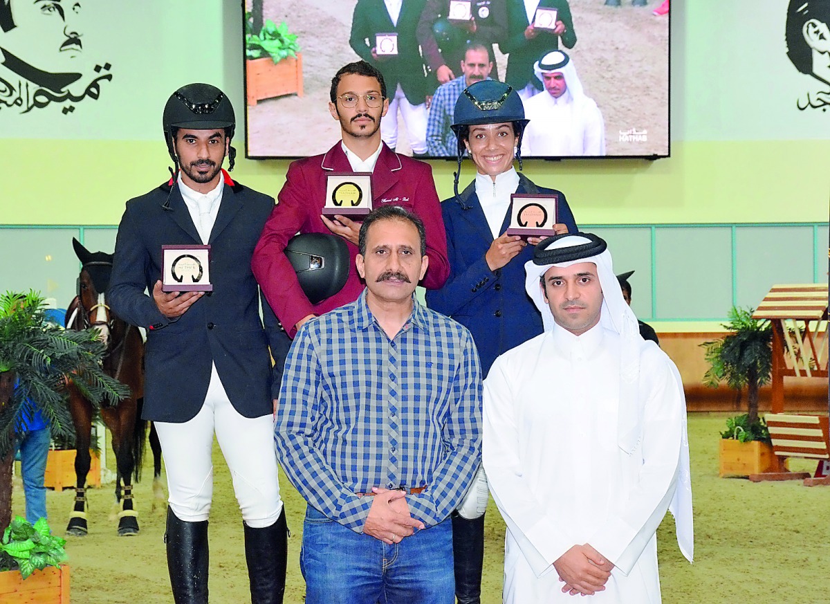 The podium winners of the Big Tour, Hamad Nasser Al Qadi, Hamad Towaim Al Marri and Cyrine Cherif pose for a photograph with officials during the awards presentation on the final day of the opening round of 2018/2019 Hathab Equestrian Tour at the Qatar Eq