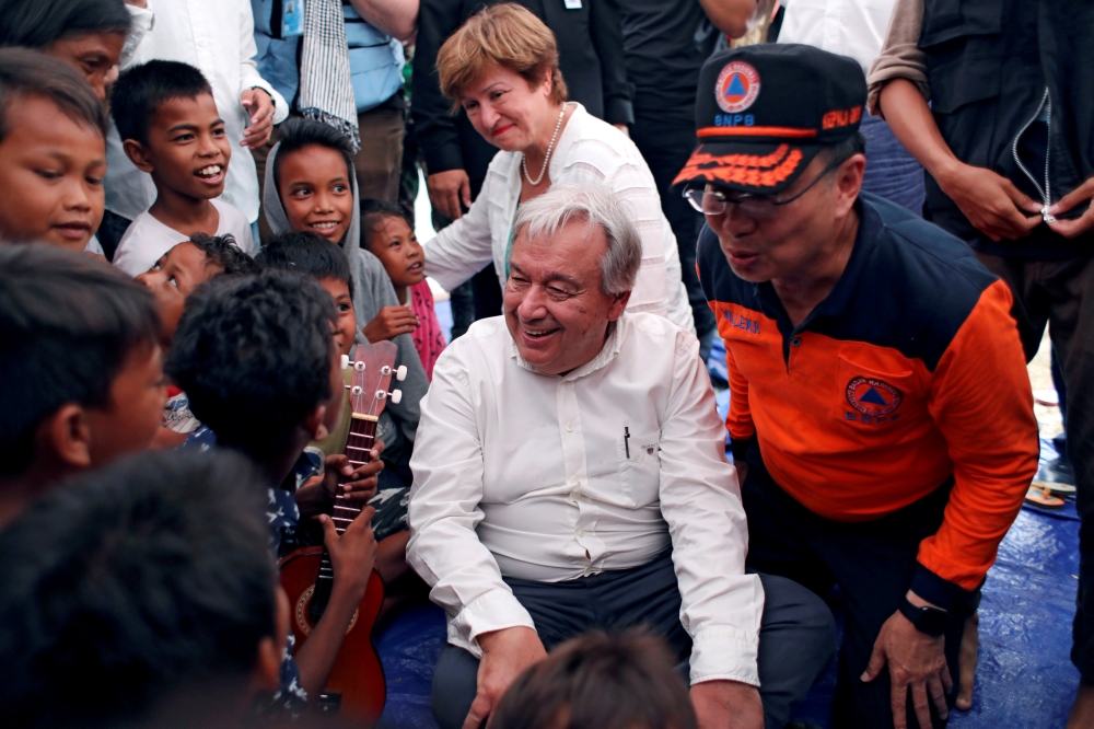 United Nations Secretary-General Antonio Guterres and World Bank CEO Kristalina Georgieva greet children while visiting a camp for displaced earthquake and liquefaction victims in Palu, Central Sulawesi, Indonesia, October 12, 2018. REUTERS/Jorge Silva
