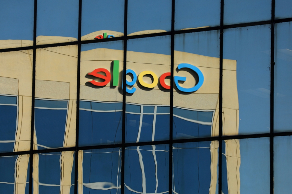 The Google logo is shown reflected on an adjacent office building in Irvine, California, August 7, 2017 (Reuters/Mike Blake) 