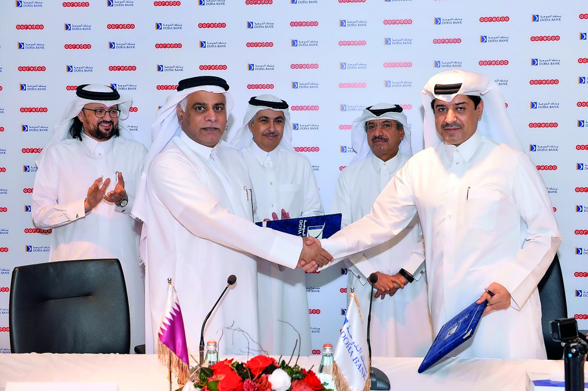 Ooredoo COO Yousuf Abdulla Al Kubaisi (left) and Doha Bank Managing Director Sheikh Abdulrahman bin Mohammad bin Jabor AI Thani shake hands after the signing agreement.