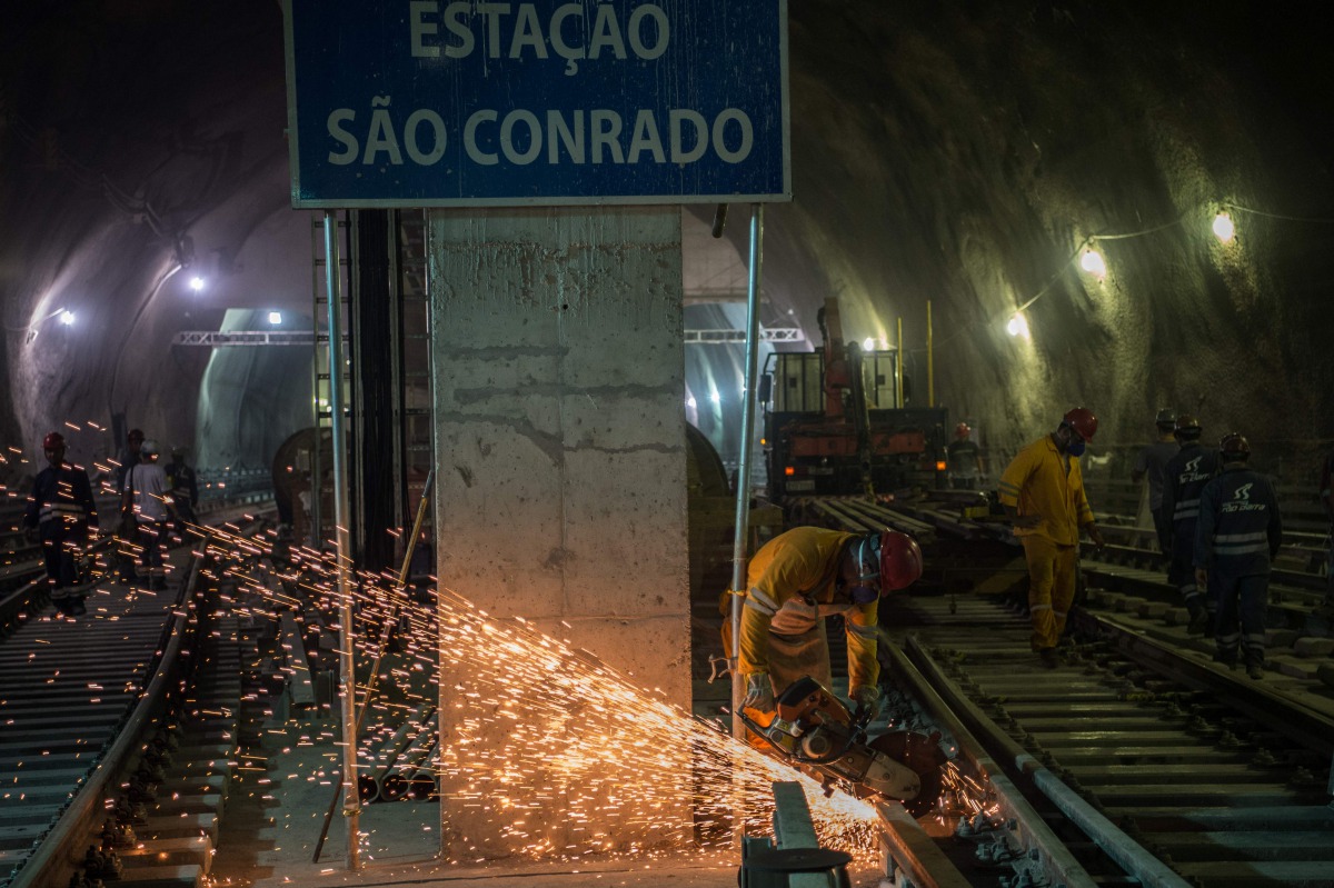 Workers are seen at the Sao Conrado metro station that will reach the Olympic Village in Rio de Janeiro, Brazil on April 13, 2016. AFP/Christophe Simon