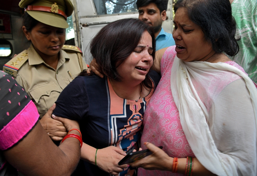 Wife of Vivek Tiwari, a sales manager for Apple, is consoled by her relatives after her husband was shot dead by a police constable in the Gomti Nagar neighbourhood of Lucknow, northern state of Uttar Pradesh, India September 29, 2018. Reuters