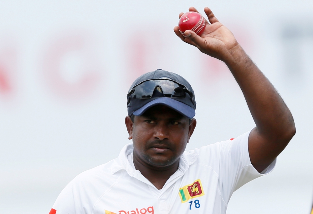 Sri Lanka's Rangana Herath shows the ball to celebrate taking six wickets after Sri Lanka won the test series. REUTERS/Dinuka Liyanawatte/File Photo