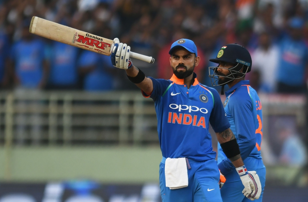 Indian cricket captain Virat Kohli raises his bat after scoring century (100 runs) during the second one day international (ODI) cricket match between India and West Indies at the Dr. Y.S. Rajasekhara Reddy ACA-VDCA Cricket Stadium in Visakhapatnam on Oct
