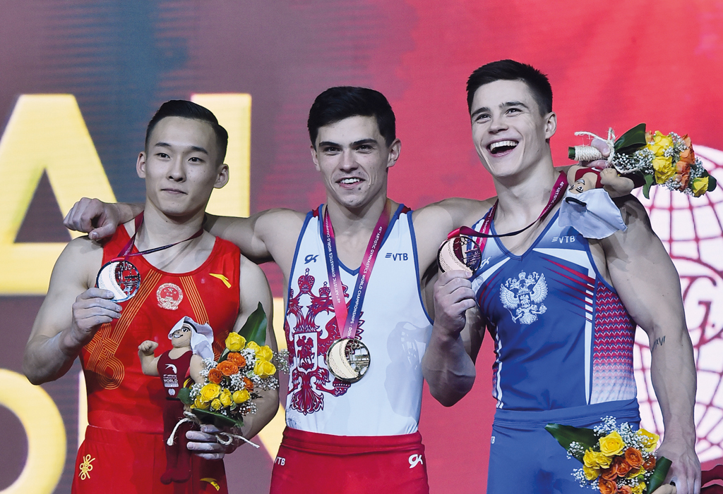 Artur Dalaloyan (centre) gold medal winner in the all-around category at the 48th Artistic Gymnastics World Championships Doha 2018 poses for a picture along with silver medal winner Xiao Ruoteng (left) of China and Nikita Nagornyy of Russia at the Aspire
