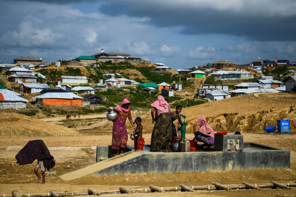 In this file photo taken on August 8, 2018 Rohingya refugees collect water at the Kutupalong refugee camp in Ukhia.  / AFP / CHANDAN KHANNA 