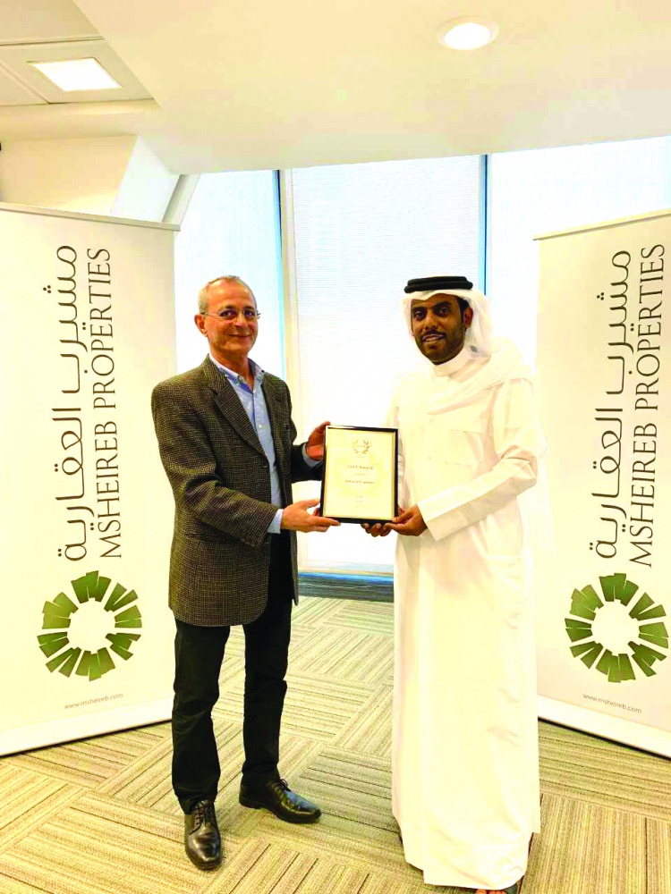 A Msheireb Properties official receiving the award.