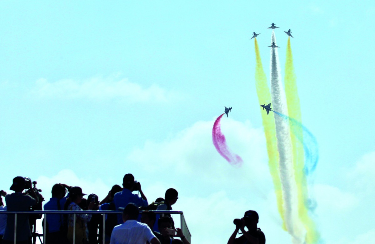 People watch J-10 fighter jets of Bayi aerobatic team of Chinese People's Liberation Army (PLA) Air Force perform at the China International Aviation and Aerospace Exhibition, or Zhuhai Airshow, in Zhuhai, Guangdong province, China November 6, 2018. China