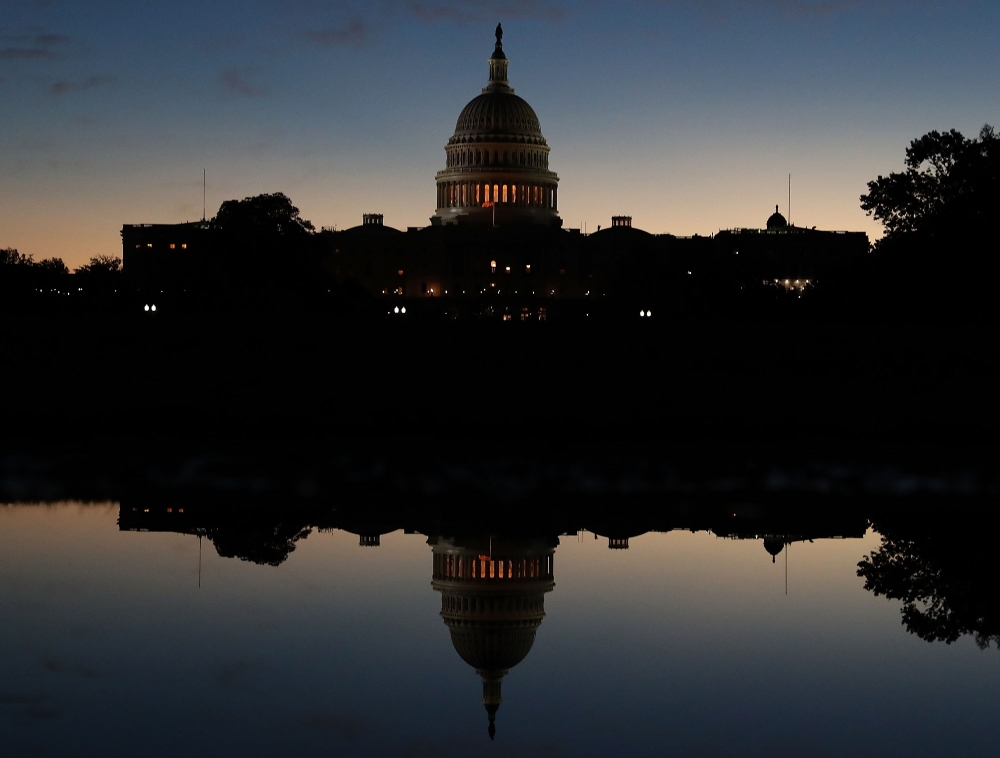 The US Capitol is reflected in a puddle of water a day after Americans voted in the midterm elections, on November 7 2018 in Washington. Mark Wilson/Getty Images/AFP