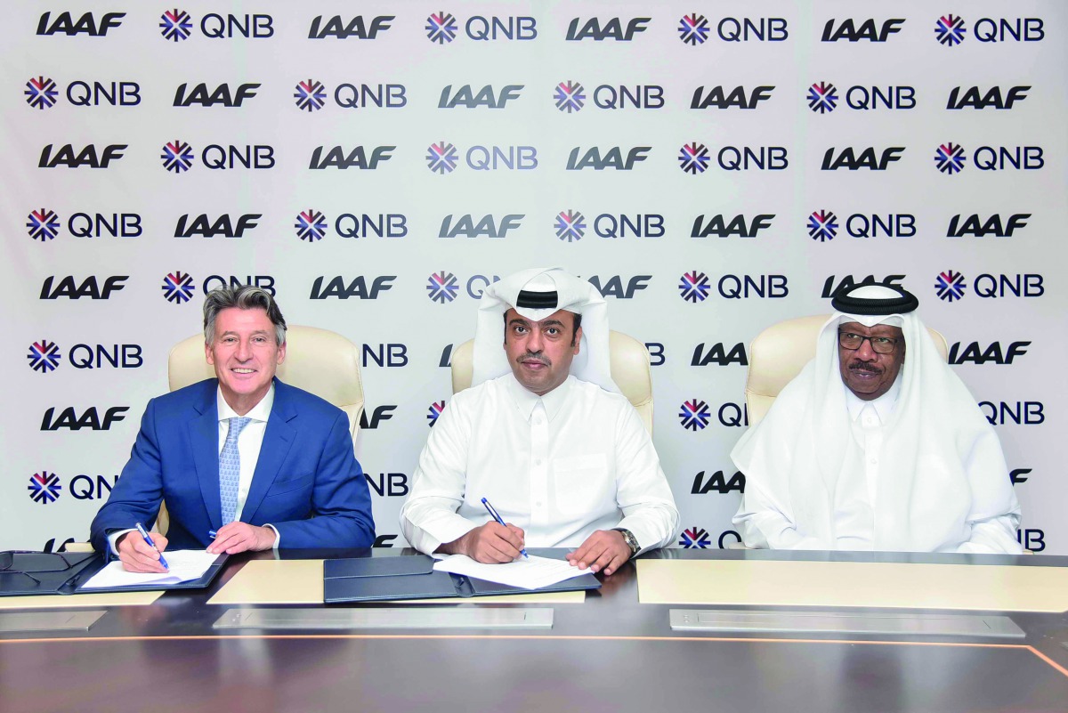 Abdulla Mubarak Al Khalifa (centre), Acting Chief Executive Officer at QNB Group;  IAAF President, Sebastian Coe (left), and Vice-President and Director General of the Local Organizing Committee and Vice-President of the IAAF,  Dahlan Al Hamad, at the sig