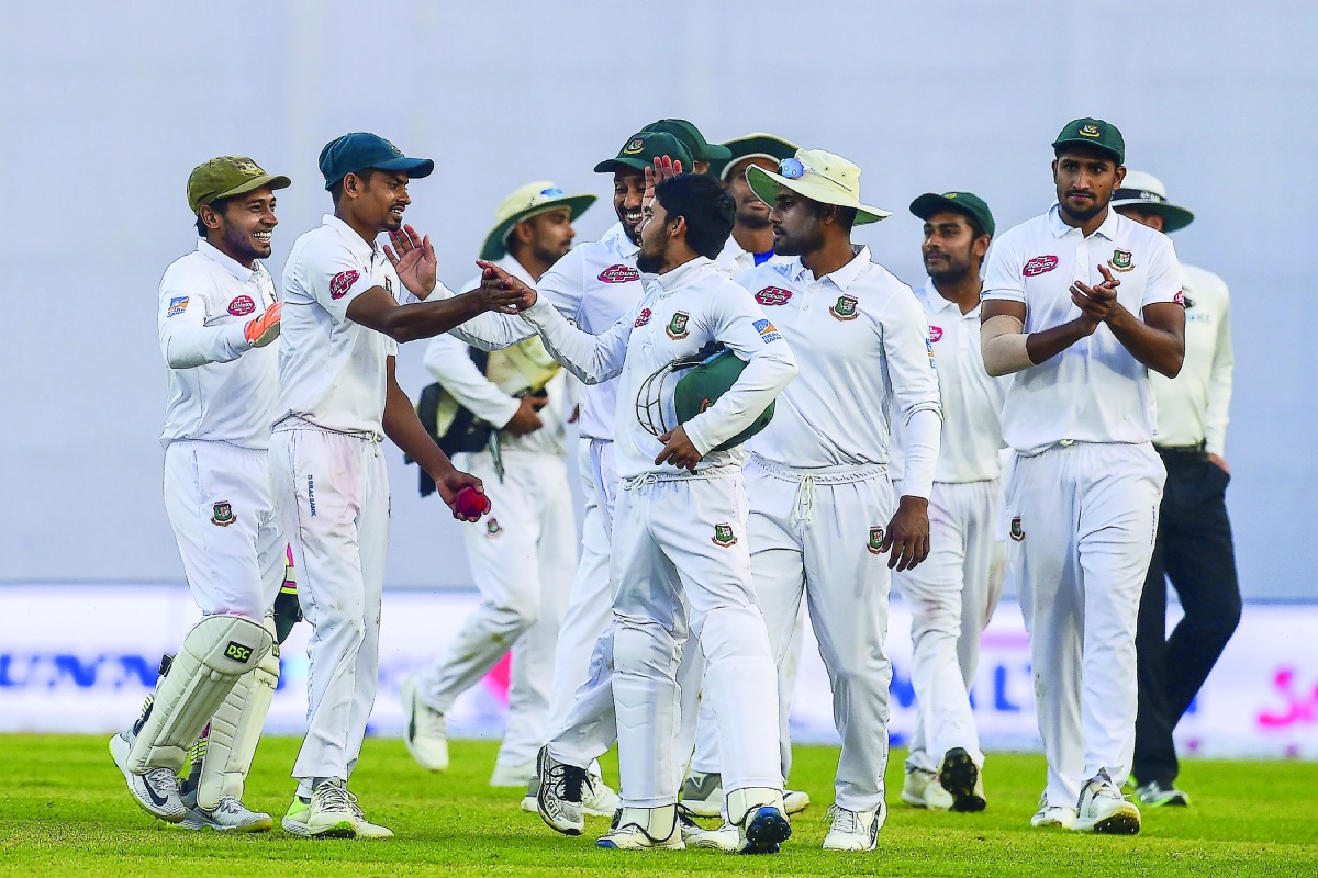 Bangladesh cricketers congratulate teammate Taijul Islam (2R) as they walk off the field after the third day of the second Test cricket match between Bangladesh and Zimbabwe at the Sher-e-Bangla National Cricket Stadium in Dhaka on November 13, 2018. AFP 