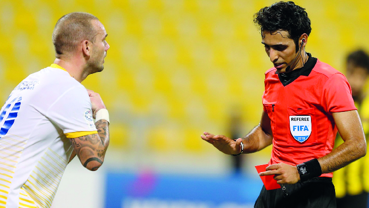 Wesley Sneidjer (left) and referee Abdull Ali Athba in this file picture of November 8.