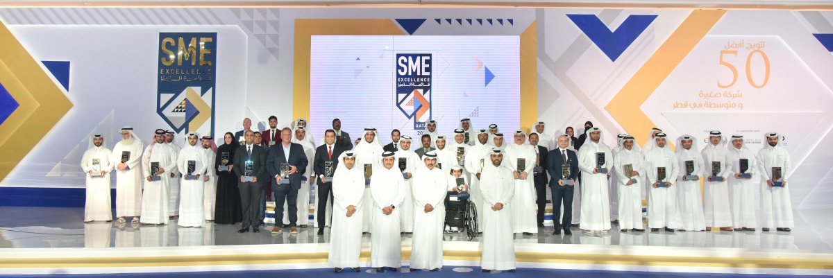 H E Sheikh Abdulla bin Saoud Al Thani  (second right), Governor of Qatar Central Bank; Abdulaziz bin Nasser Al Khalifa (right), CEO of Qatar Development Bank; and Sheikh Khalifa bin Jassim Al Thani (second left), Chairman of Qatar Chamber, with the winner