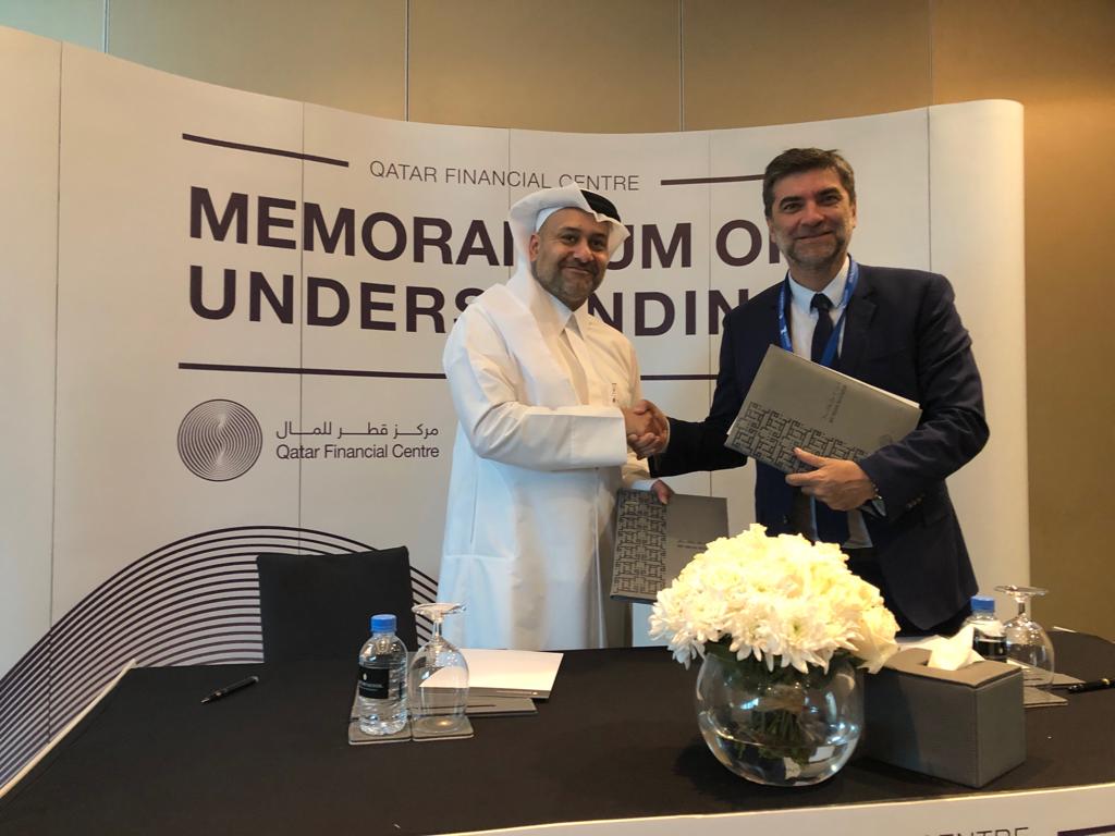Yousuf Mohamed Al Jaida (left), CEO of Qatar Financial Centre, shaking hands with the official of  LexisNexis, after the signing of the MoU in Doha.